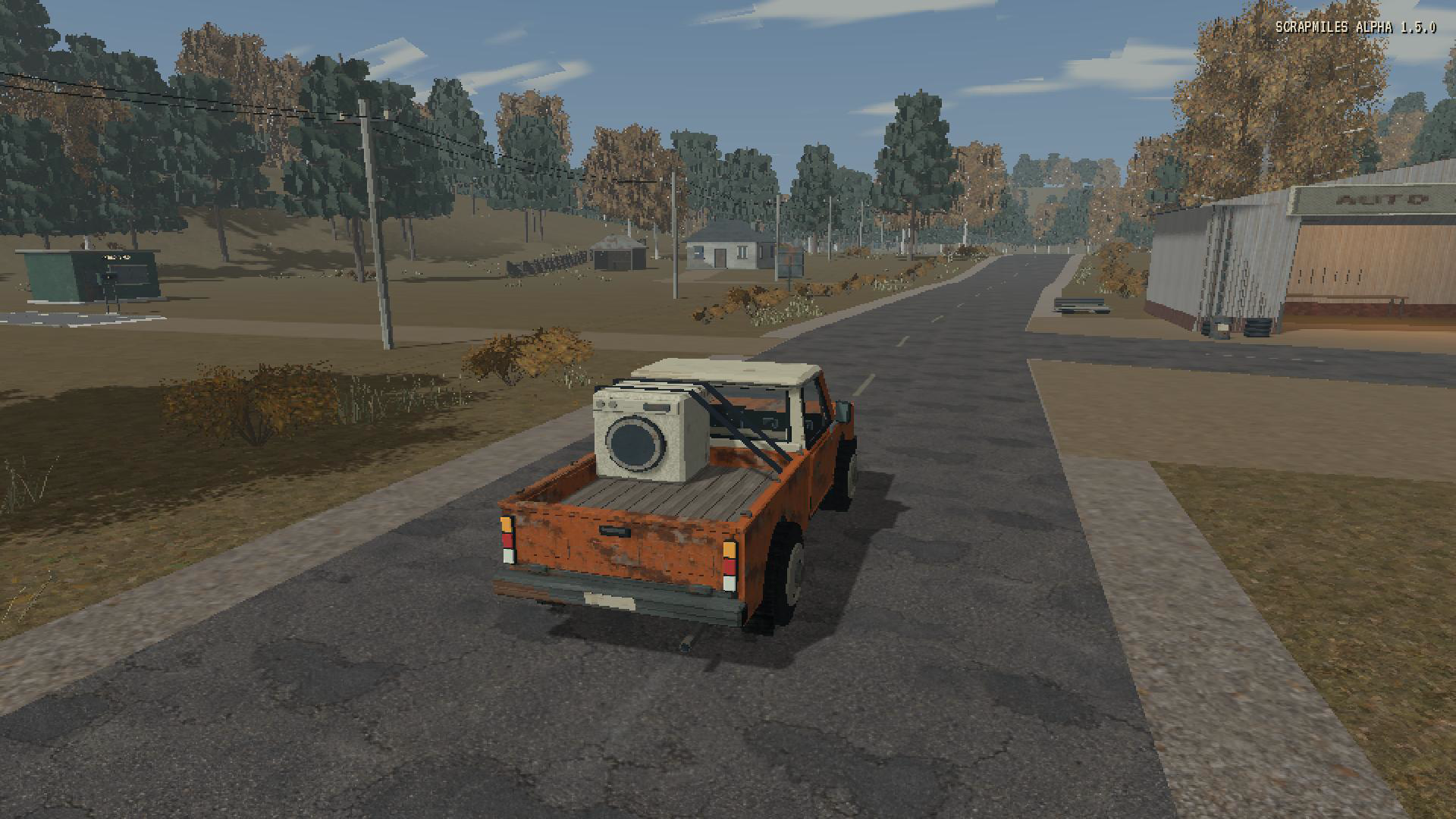 Driving a pickup carrying a secured washing machine along an autumn country road.
